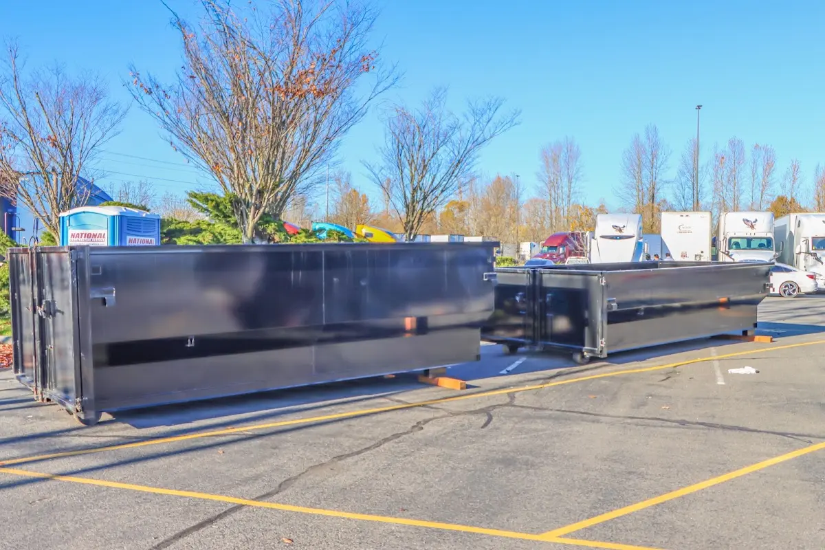 Professional dumpster rental service with roll-off container on residential driveway in La Follette